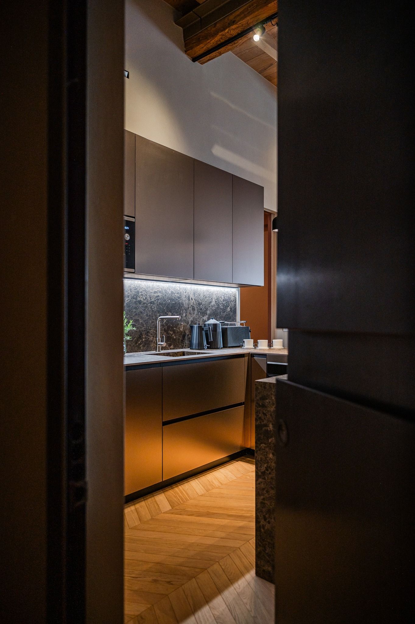 A glimpse of the kitchen through the half-open door