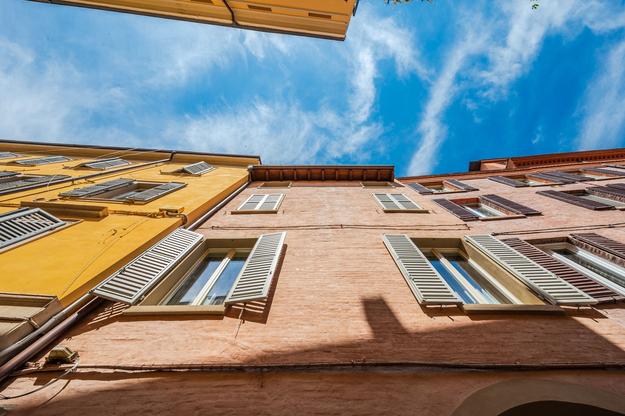 The palazzo facade seen from below, against the sky